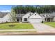 White two-story house with gray stone accents, two-car garage, and landscaped lawn at 320 Sobeck Way, Canton, GA 30115