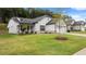 Two-story house with white siding, gray stone accents, and a lush green lawn at 320 Sobeck Way, Canton, GA 30115