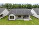 Rear view of house showing covered patio and yard at 320 Sobeck Way, Canton, GA 30115