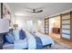 Main bedroom with a king-size bed and sliding barn doors to the en-suite bath at 4485 Coventry Ne Way, Roswell, GA 30075