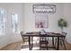 Light-filled dining area features hardwood floors and a rustic dining table at 4485 Coventry Ne Way, Roswell, GA 30075