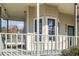 Inviting front porch with a swing and gray railing at 4485 Coventry Ne Way, Roswell, GA 30075