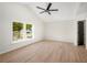 Bright bedroom with ceiling fan and wood-look flooring at 5541 Downs Way, Lithonia, GA 30058