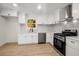 Modern kitchen with white cabinets, quartz countertops, and stainless steel appliances at 5541 Downs Way, Lithonia, GA 30058