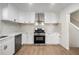 Modern kitchen with white cabinets, quartz countertops and stainless steel appliances at 5541 Downs Way, Lithonia, GA 30058