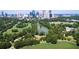 Aerial view of park with pond, trees, and city skyline at 1393 Lanier Pl, Atlanta, GA 30306