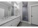 Modern bathroom with double vanity, marble countertop, and walk-in shower at 1393 Lanier Ne Pl, Atlanta, GA 30306