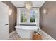 Elegant bathroom with soaking tub, chandelier, and marble accents at 1393 Lanier Ne Pl, Atlanta, GA 30306