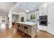 Modern kitchen with white cabinets, a large island, and stainless steel appliances at 1393 Lanier Ne Pl, Atlanta, GA 30306