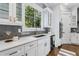 Modern kitchen with white cabinets, quartz countertops, and stainless steel appliances at 1393 Lanier Pl, Atlanta, GA 30306