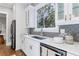 Modern kitchen with white cabinets, quartz countertops, and stainless steel appliances at 1393 Lanier Pl, Atlanta, GA 30306