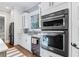 Modern kitchen features stainless steel appliances and white cabinetry at 1393 Lanier Ne Pl, Atlanta, GA 30306