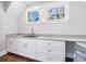 Bright laundry room with white cabinets and double sink at 1393 Lanier Pl, Atlanta, GA 30306