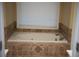 Relaxing bathtub with tile surround in a bright bathroom at 2815 Shoemaker Ln, Snellville, GA 30039