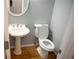 Small bathroom with pedestal sink and toilet at 2815 Shoemaker Ln, Snellville, GA 30039