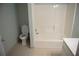 Bathroom with tub, toilet and flooring at 2815 Shoemaker Ln, Snellville, GA 30039