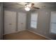 Bedroom with ceiling fan, neutral walls, and double closets at 2815 Shoemaker Ln, Snellville, GA 30039