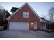 Attached two-car garage with white door and exterior side door at 2815 Shoemaker Ln, Snellville, GA 30039