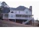 Two-story house with white siding, large deck, and stairs leading to the backyard at 2815 Shoemaker Ln, Snellville, GA 30039