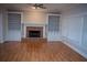 Living room with hardwood floors, built-in shelving, and a brick fireplace at 2815 Shoemaker Ln, Snellville, GA 30039