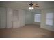 Large main bedroom with built-in shelving, ceiling fan and window at 2815 Shoemaker Ln, Snellville, GA 30039