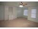 Large main bedroom with built-in shelving, ceiling fan and window at 2815 Shoemaker Ln, Snellville, GA 30039