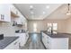 Modern kitchen with white cabinets, dark countertops, and vinyl flooring at 30 Sportsman Path, Dallas, GA 30157