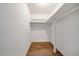 Walk-in closet with shelving and wood-look flooring at 3142 Reeves Se St, Smyrna, GA 30080