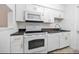 White kitchen with granite countertops and appliances at 3142 Reeves Se St, Smyrna, GA 30080