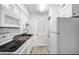 White kitchen with granite countertops and appliances at 3142 Reeves Se St, Smyrna, GA 30080