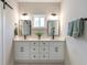 Double vanity bathroom with white cabinets and frameless mirrors at 3463 Victoria St, Atlanta, GA 30337