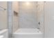 Clean bathroom with a tub and marble tile at 3463 Victoria St, Atlanta, GA 30337