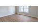 Empty bedroom with wood-look flooring and large windows at 3463 Victoria St, Atlanta, GA 30337