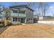 Modern two-story house with gray and teal siding, a porch, and a yard at 3463 Victoria St, Atlanta, GA 30337