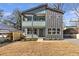 Modern two-story home with gray and teal siding, a porch, and a small yard at 3463 Victoria St, Atlanta, GA 30337