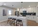 Modern kitchen with white cabinets, quartz countertops, stainless steel appliances, and island with seating at 3463 Victoria St, Atlanta, GA 30337