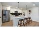 Modern kitchen with white cabinets, quartz countertops, stainless steel appliances, and island with seating at 3463 Victoria St, Atlanta, GA 30337