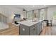 Open concept kitchen island with gray cabinets and white countertop at 405 Brooch Way, Stockbridge, GA 30281