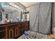 A full bathroom with dual vanity, zebra print shower curtain, and zebra rug at 1275 Poole Bridge Rd, Hiram, GA 30141