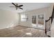 Bright living room featuring hardwood floors, ceiling fan, and stairway at 168 Ellis Dr, Conyers, GA 30012