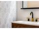 Bathroom sink with wood cabinet and gold faucet at 404 Granville Ct, Atlanta, GA 30328