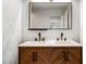 Double vanity with wood cabinets, white countertop, and gold fixtures at 404 Granville Ct, Atlanta, GA 30328