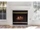 Modern fireplace with marble hearth and wood burning fire at 404 Granville Ct, Atlanta, GA 30328