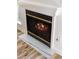 Modern fireplace with marble hearth and wood burning fire at 404 Granville Ct, Atlanta, GA 30328