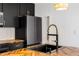 Modern kitchen with stainless steel appliances and a gold faucet at 404 Granville Ct, Atlanta, GA 30328