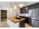 Stylish kitchen featuring dark cabinetry, herringbone countertops, and stainless steel appliances at 404 Granville Ct, Atlanta, GA 30328