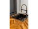 Modern kitchen sink with gold faucet and herringbone wood countertop at 404 Granville Ct, Atlanta, GA 30328