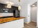 Updated kitchen with dark cabinetry, herringbone countertops and a breakfast bar at 404 Granville Ct, Atlanta, GA 30328