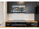 Stainless steel microwave installed in dark kitchen cabinets at 404 Granville Ct, Atlanta, GA 30328