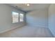 Well-lit bedroom with neutral walls, carpet, and a large window at 108 Dalston Cv, Stockbridge, GA 30281